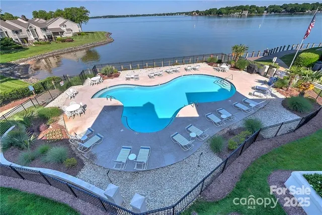 an aerial view of a house with outdoor space and lake view