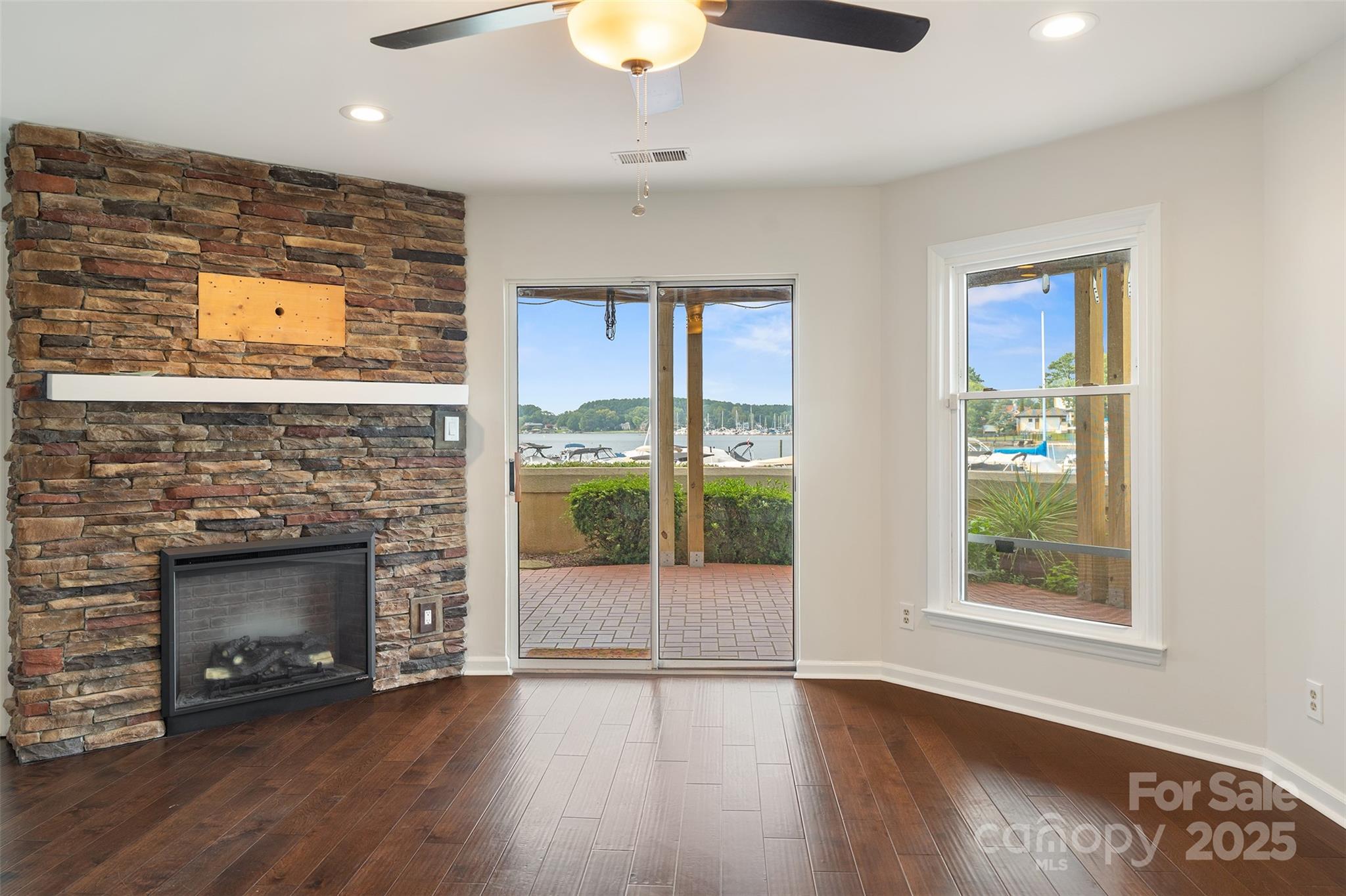 18647 Vineyard Point Lane Cornelius, NC 28031 - Photo 19 of 36 an empty room with windows and fireplace