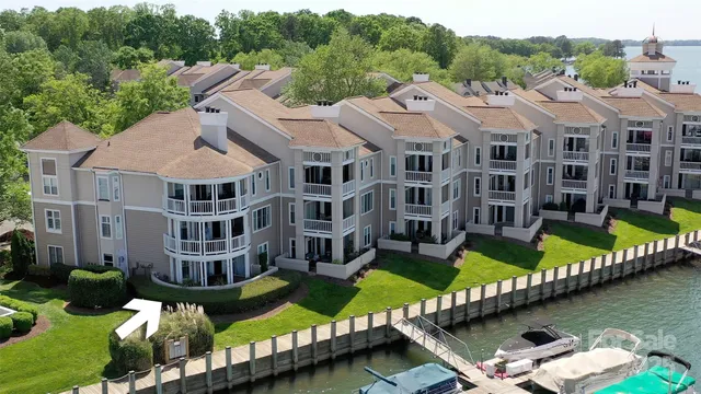an aerial view of a house with swimming pool lawn chairs and a yard