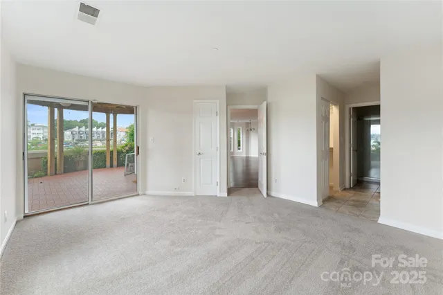 a view of an empty room with glass door