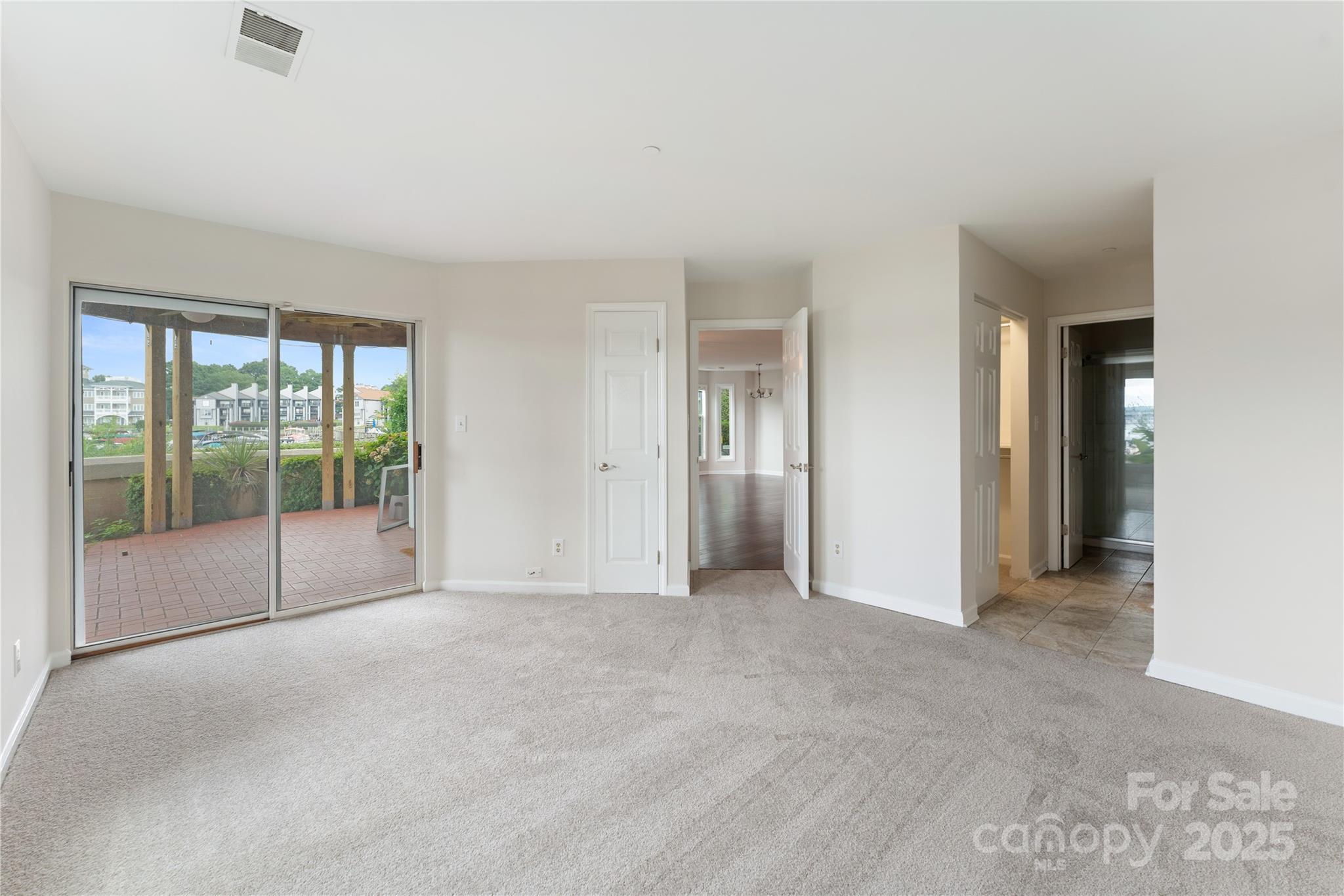 18647 Vineyard Point Lane Cornelius, NC 28031 - Photo 26 of 36 a view of an empty room with glass door