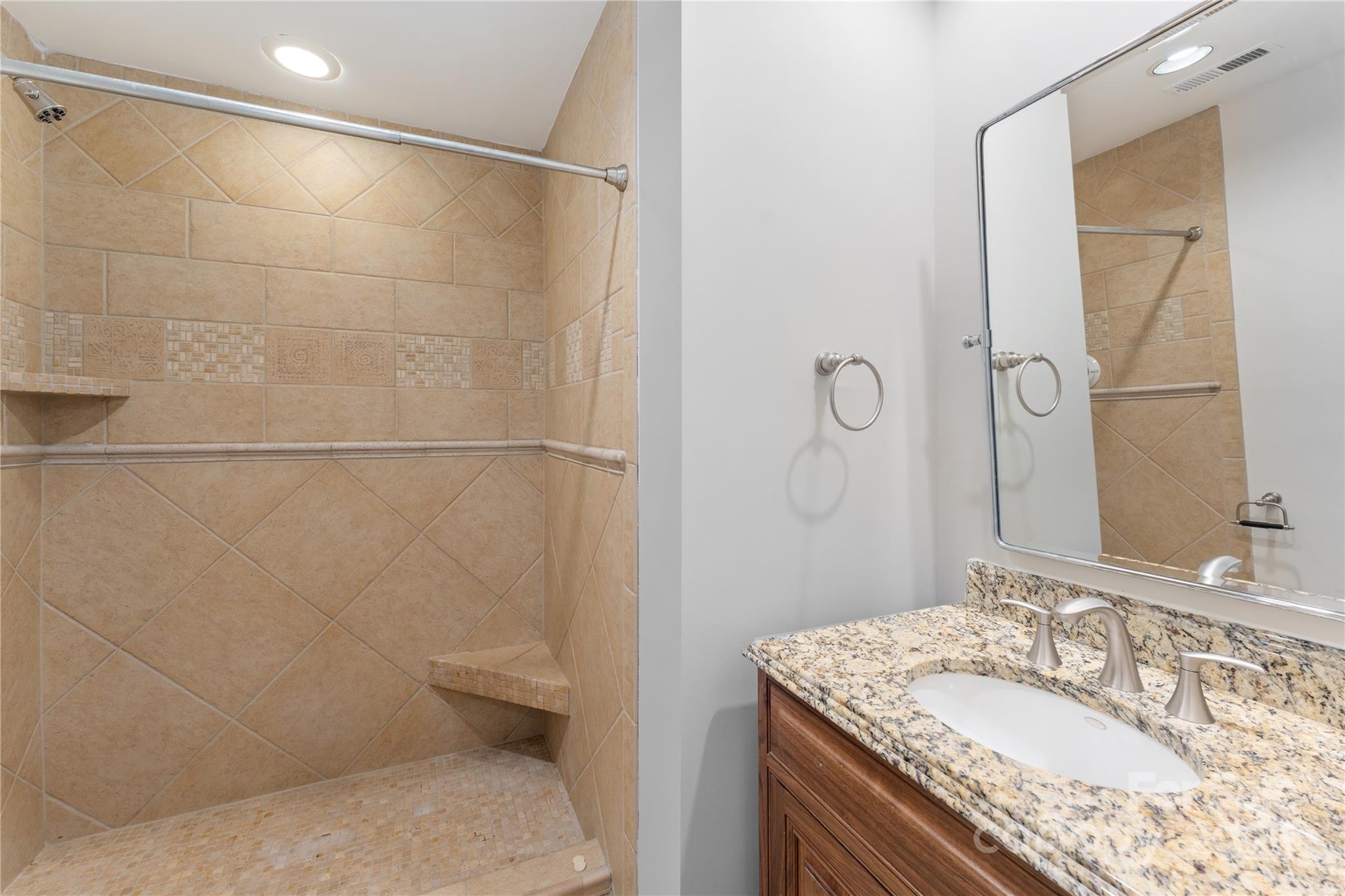 18647 Vineyard Point Lane Cornelius, NC 28031 - Photo 27 of 36 a bathroom with a granite countertop sink a toilet and shower