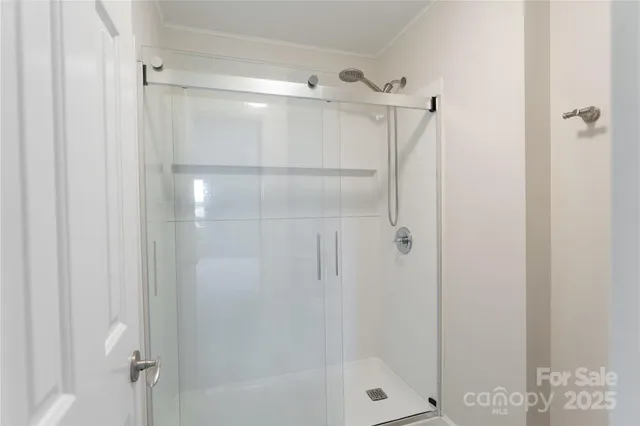 a bathroom with a glass shower door