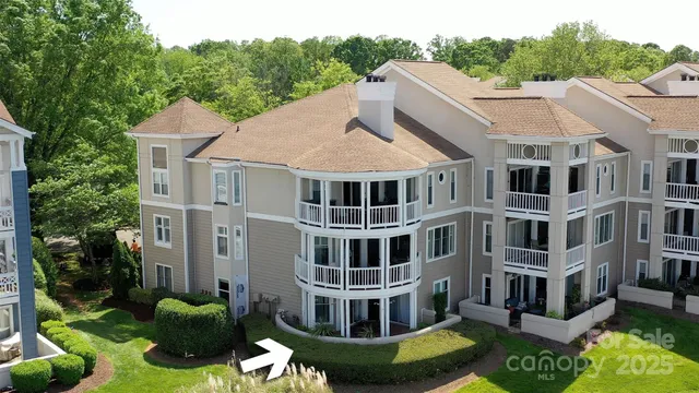 a aerial view of a house next to a yard