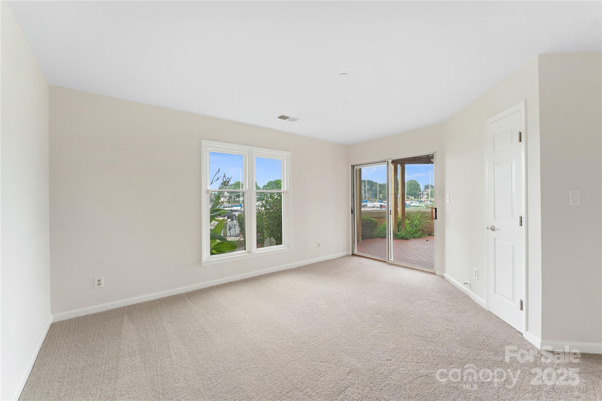 18647 Vineyard Point Lane Cornelius, NC 28031 - Photo 31 of 36 a view of a big room with windows and chandelier fan