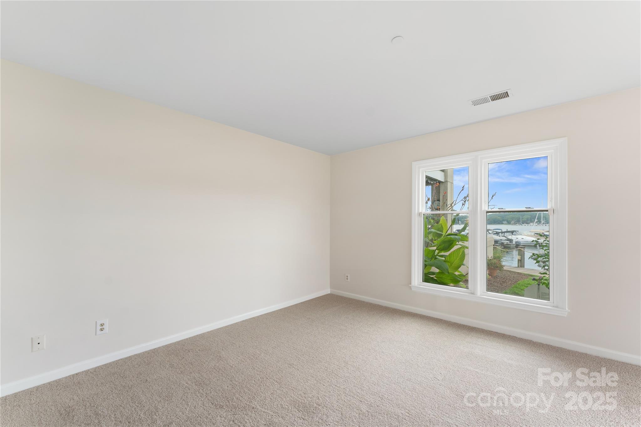 18647 Vineyard Point Lane Cornelius, NC 28031 - Photo 33 of 36 an empty room with windows