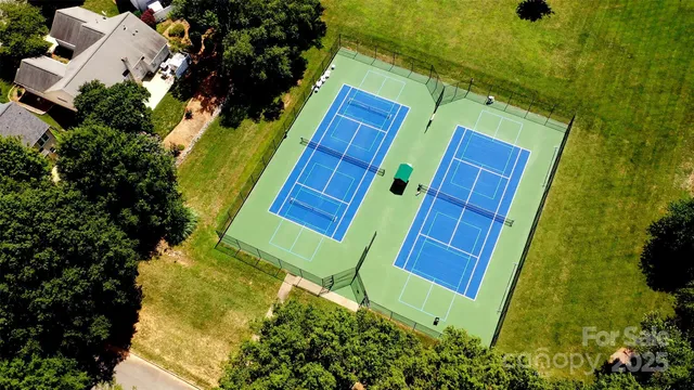 an aerial view of a house with a yard and garden
