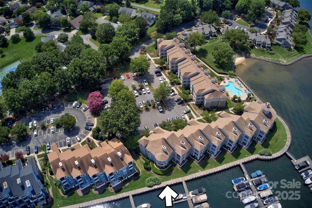 an aerial view of a house with outdoor space and lake view