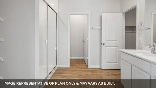 a bathroom with a sink a mirror and shower