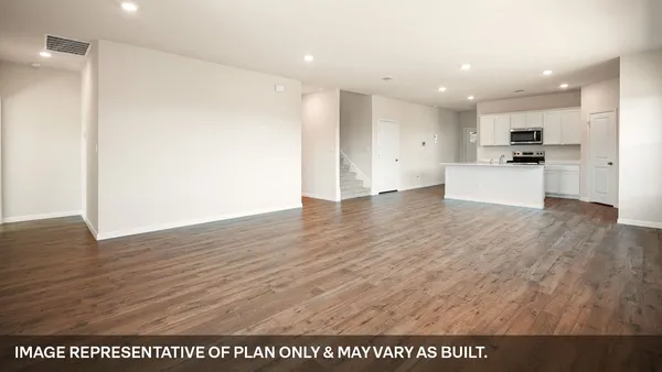 a kitchen with stainless steel appliances granite countertop a stove a microwave and a refrigerator