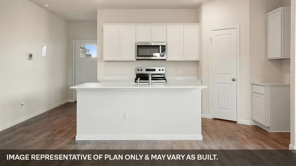 a kitchen with a sink a stove and cabinets