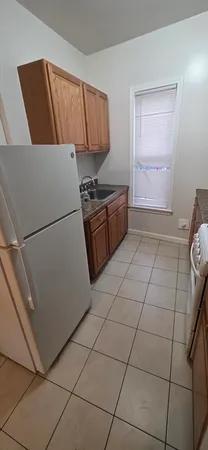 a kitchen with a stove a refrigerator and a sink