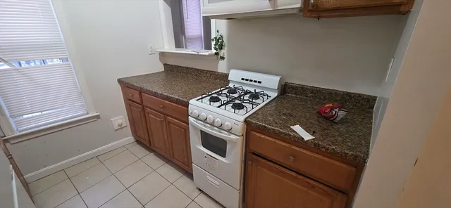 a kitchen with white cabinets and appliances