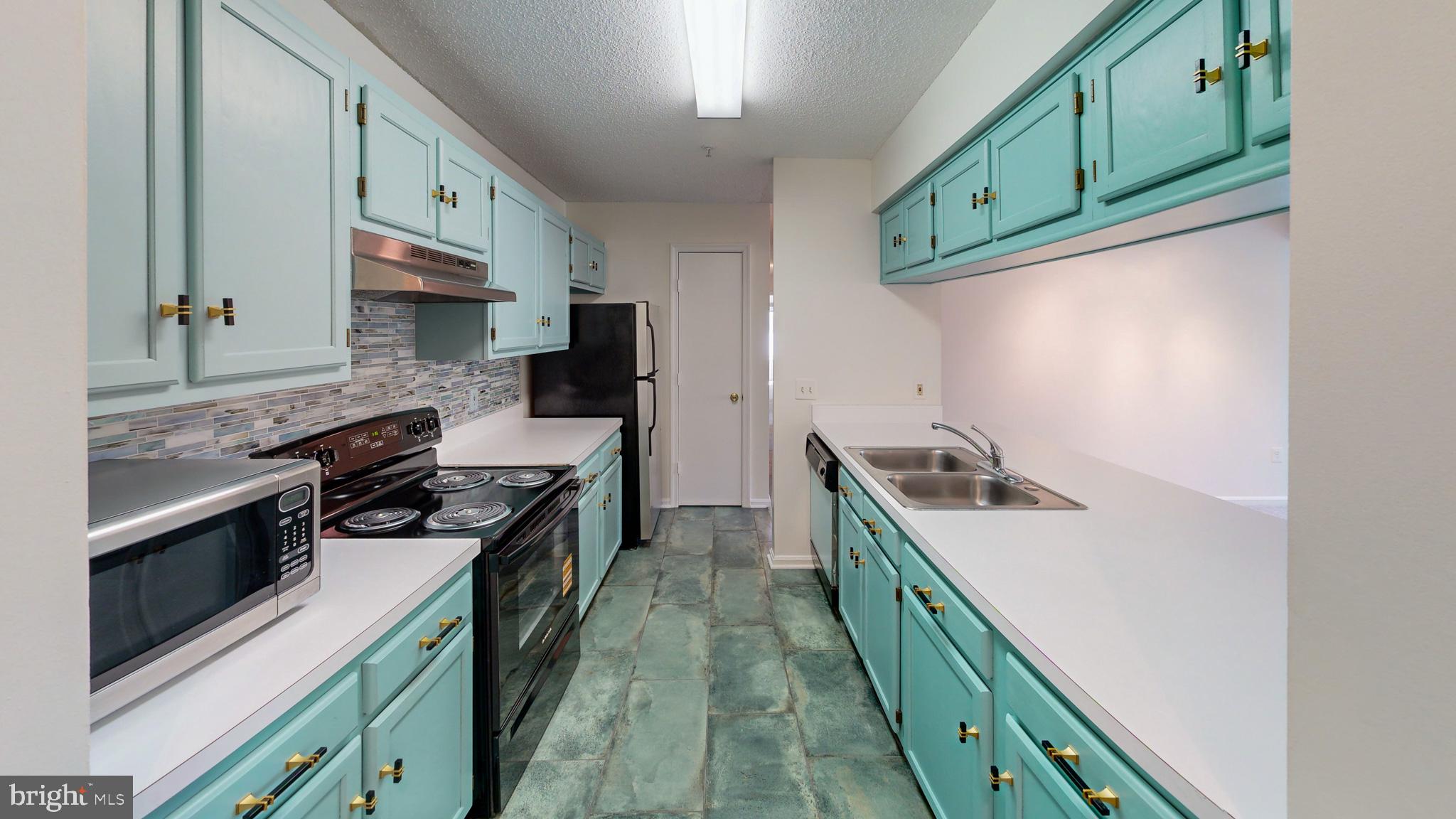 a kitchen with stainless steel appliances granite countertop a stove and a sink