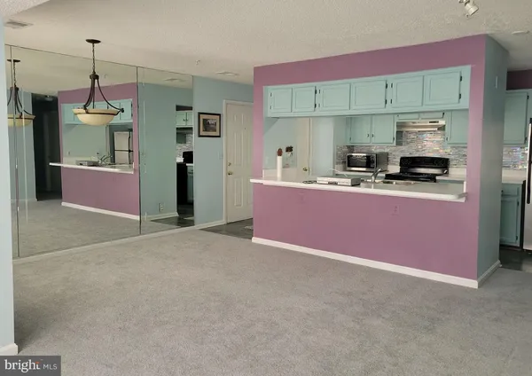 a kitchen with granite countertop a sink stove and refrigerator