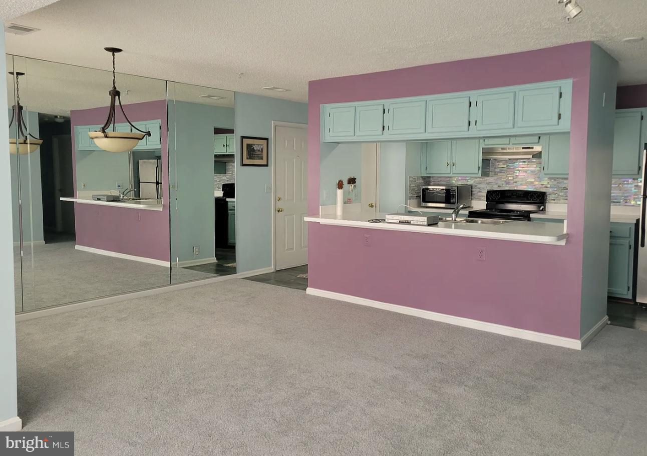 2806 Clear Shot Drive, Unit 3 Silver Spring, MD 20906 - Photo 15 of 20 a kitchen with granite countertop a sink stove and refrigerator