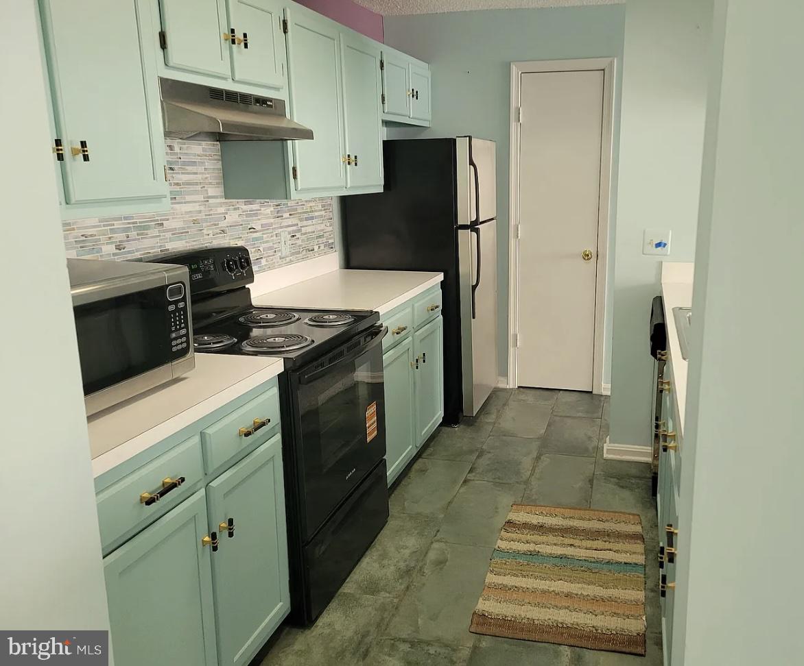 2806 Clear Shot Drive, Unit 3 Silver Spring, MD 20906 - Photo 16 of 20 a kitchen with stainless steel appliances granite countertop a refrigerator and a stove