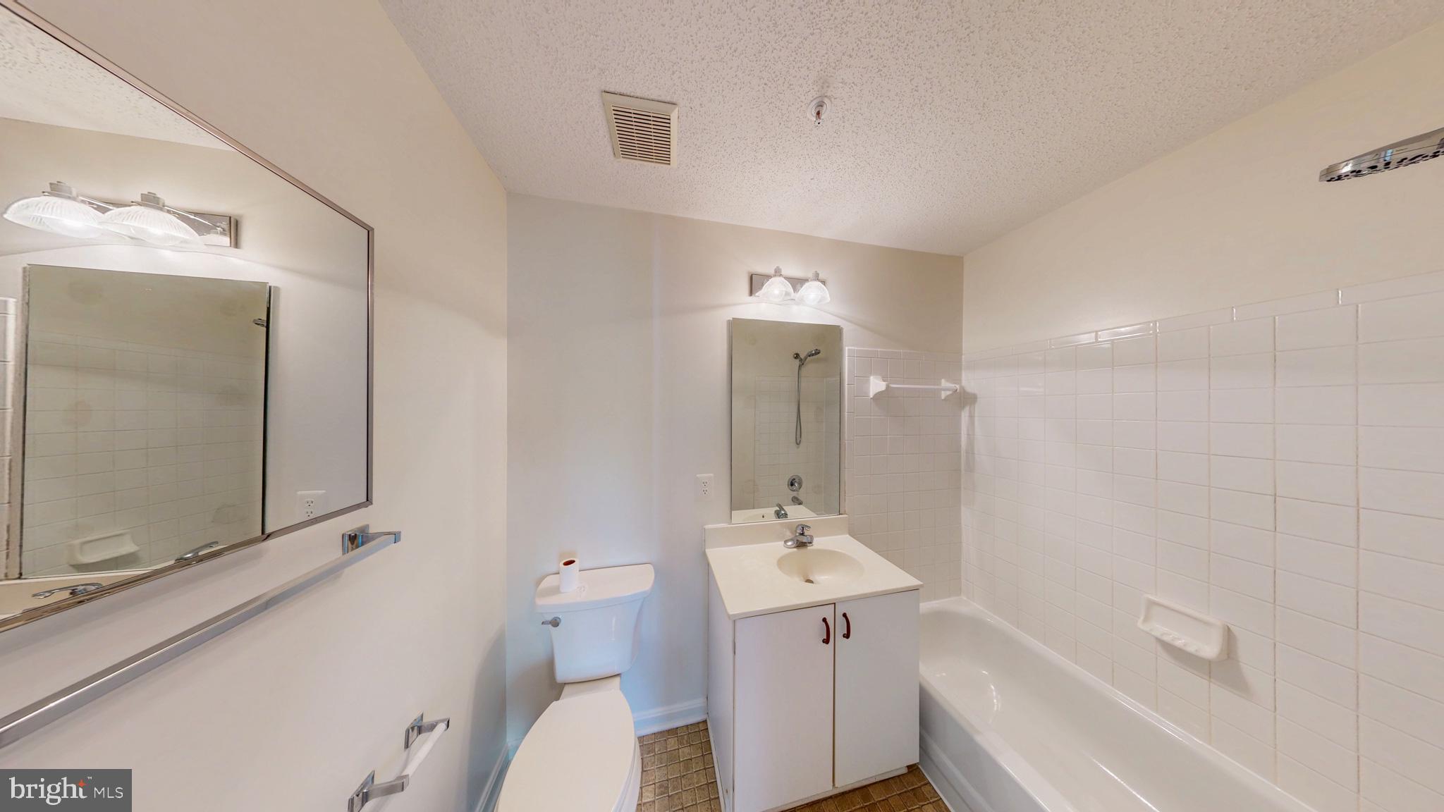 2806 Clear Shot Drive, Unit 3 Silver Spring, MD 20906 - Photo 6 of 20 a bathroom with a tub sink and mirror