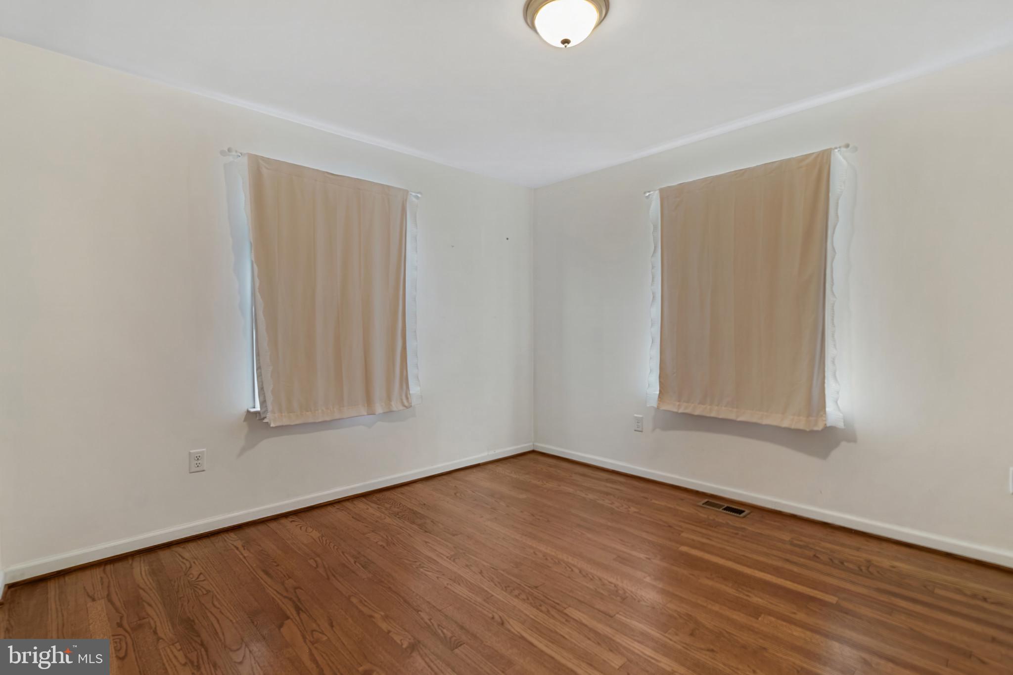 3218 Brethren Church Road Myersville, MD 21773 - Photo 18 of 30 an empty room with wooden floor and windows
