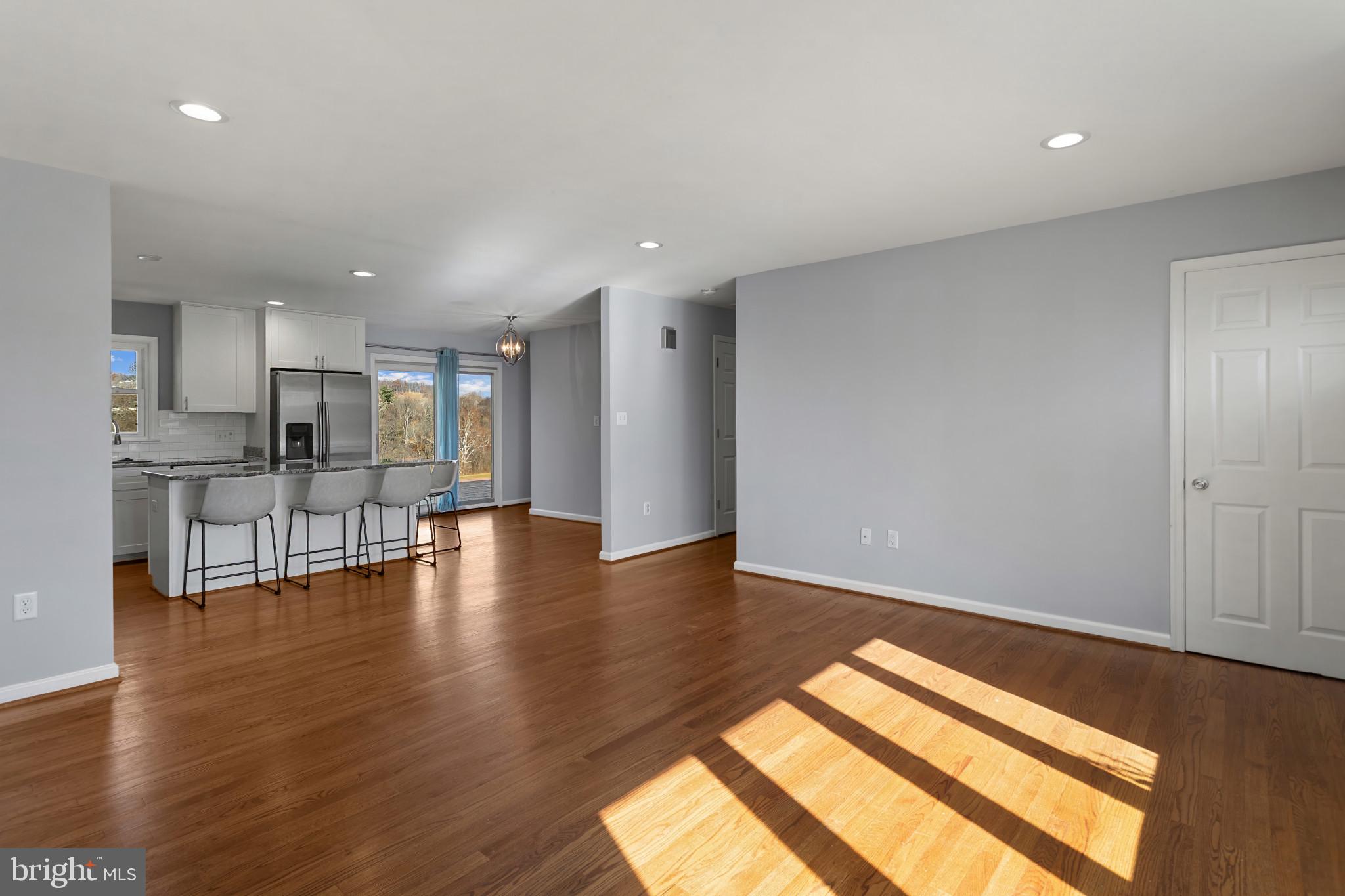 3218 Brethren Church Road Myersville, MD 21773 - Photo 5 of 30 a view of empty room with wooden floor and kitchen
