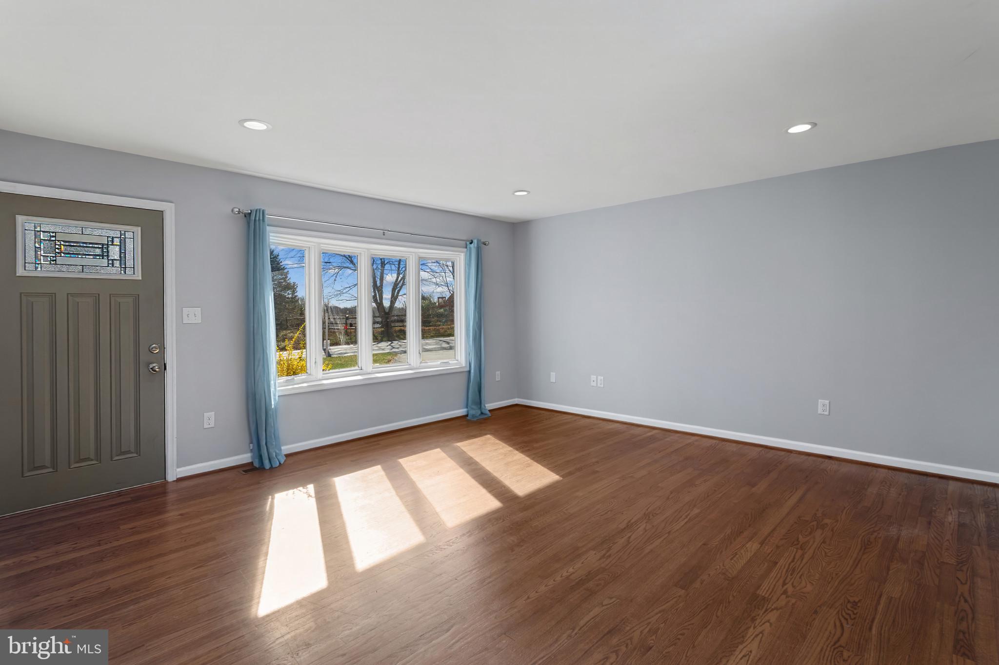 3218 Brethren Church Road Myersville, MD 21773 - Photo 7 of 30 a view of an empty room with wooden floor and a window