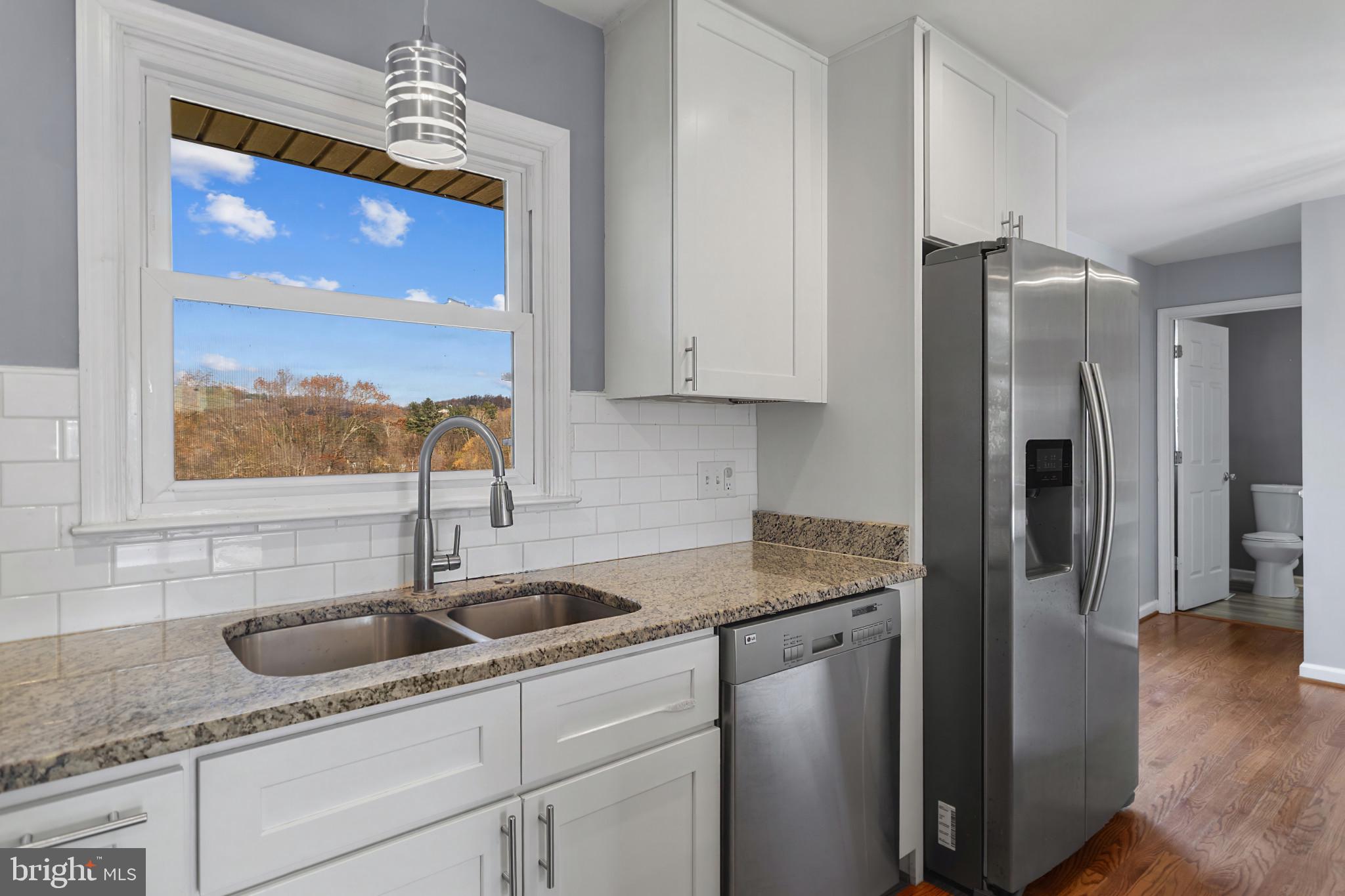 3218 Brethren Church Road Myersville, MD 21773 - Photo 10 of 30 a kitchen with stainless steel appliances granite countertop a sink and a refrigerator