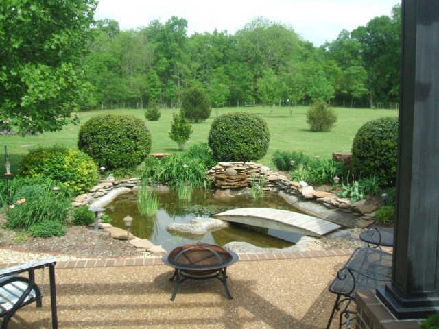 1867 Bethbirei Road Lewisburg, TN 37091 - Photo 18 of 20 NOW LETS GO OUT BACK TO ENJOY THE VIEW FROM THE BACK OF THE HOUSE...THIS IS STANDING ON THE PATIO LOOKING OVER THE WATERGARDEN/POND INTO THE BACK OF PROPERTY THAT IS COMPLETELY FENCED