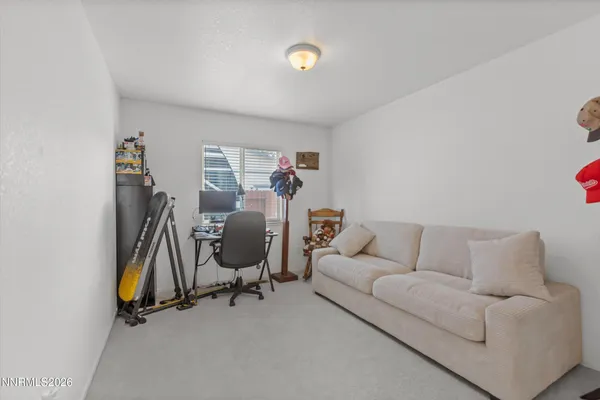a view of a livingroom with workspace and a couch