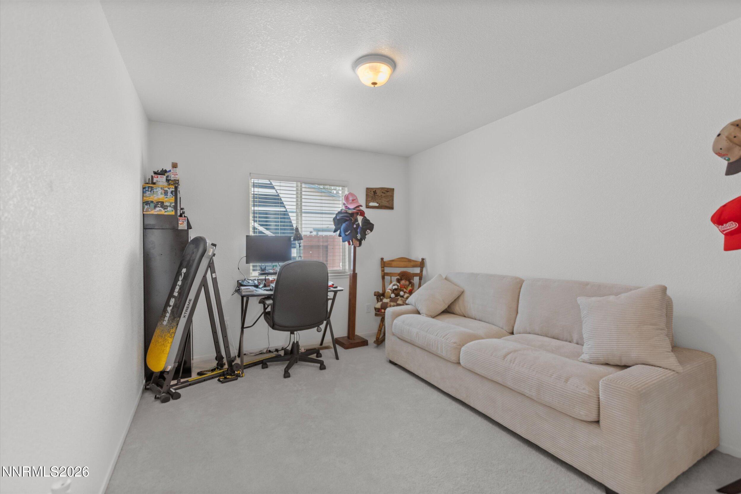 17533 Javalina Court Reno, NV 89508 - Photo 14 of 26 a view of a livingroom with workspace and a couch