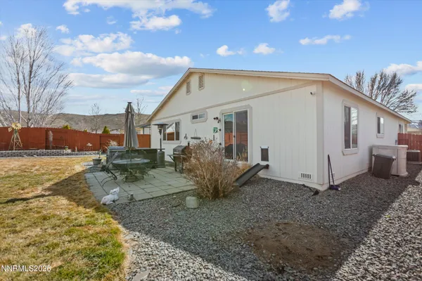 a view of a house with backyard and sitting area