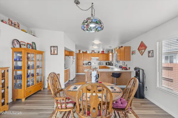 a view of a dining room with furniture a chandelier and wooden floor