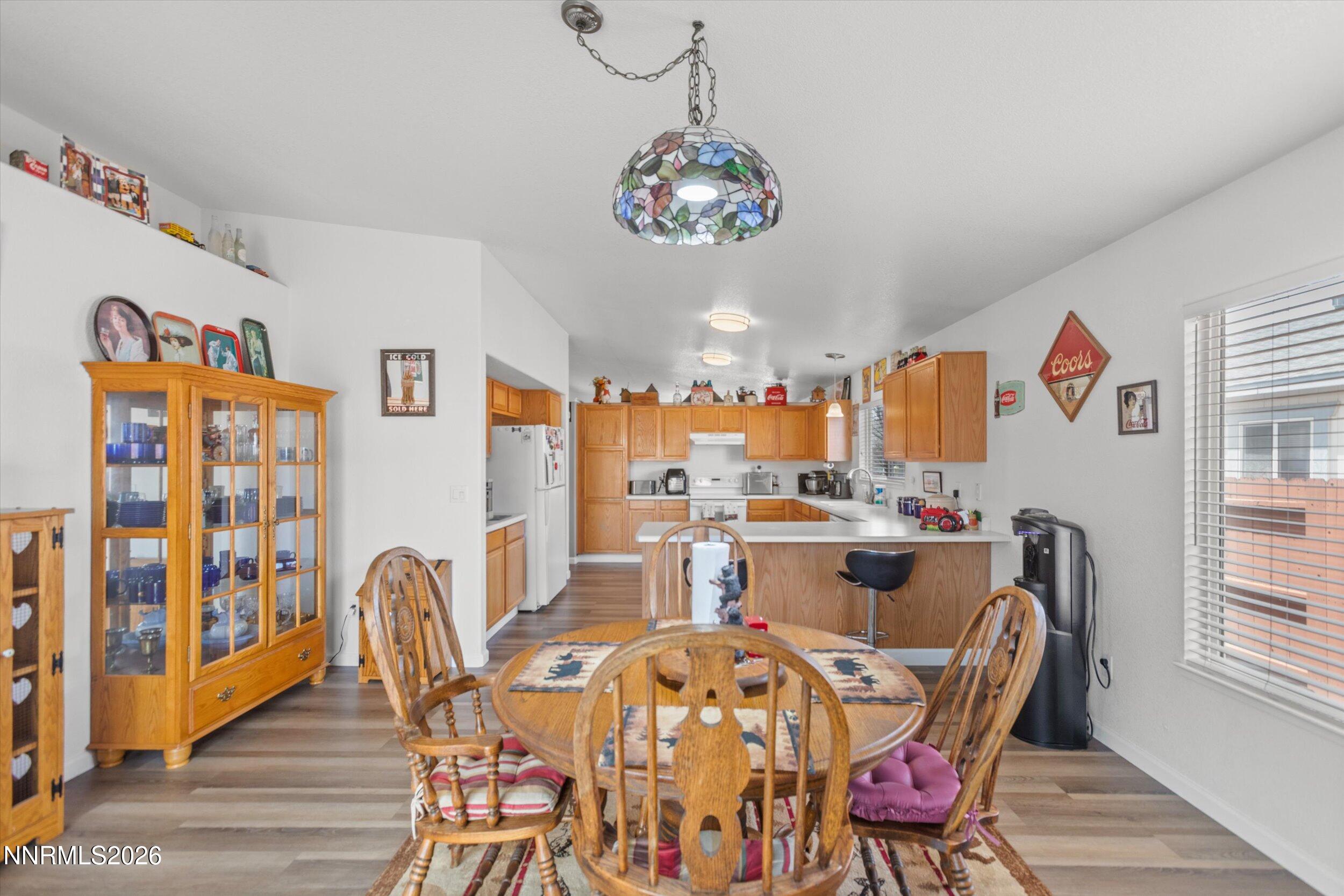 17533 Javalina Court Reno, NV 89508 - Photo 6 of 26 a view of a dining room with furniture a chandelier and wooden floor