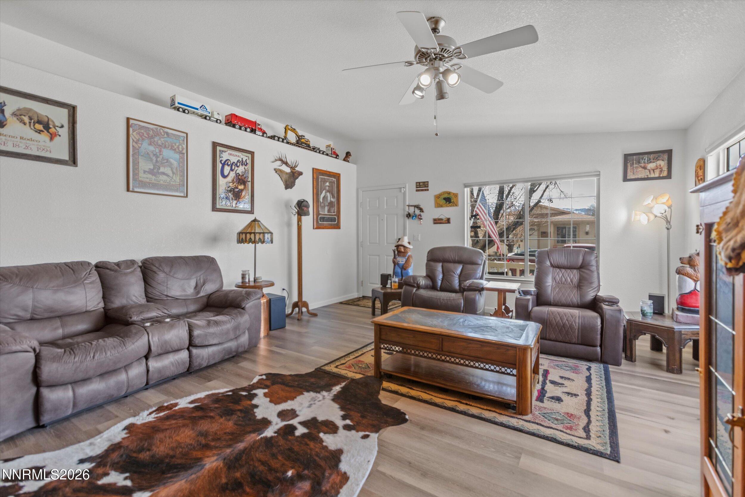17533 Javalina Court Reno, NV 89508 - Photo 8 of 26 a living room with furniture ceiling fan and a rug