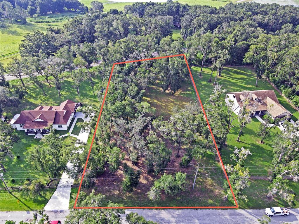 35174 Roth Lane Dade City, FL 33525 - Photo 12 of 22 an aerial view of a house with a yard and lake view