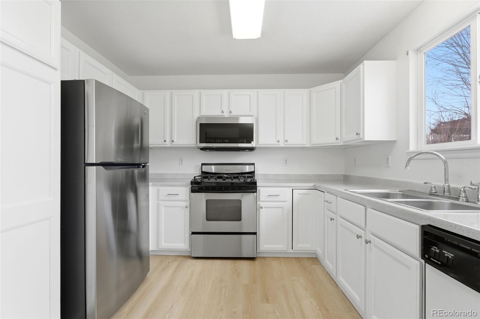 10505 Madison Way Northglenn, CO 80233 - Photo 15 of 49 a kitchen with a refrigerator stove and sink