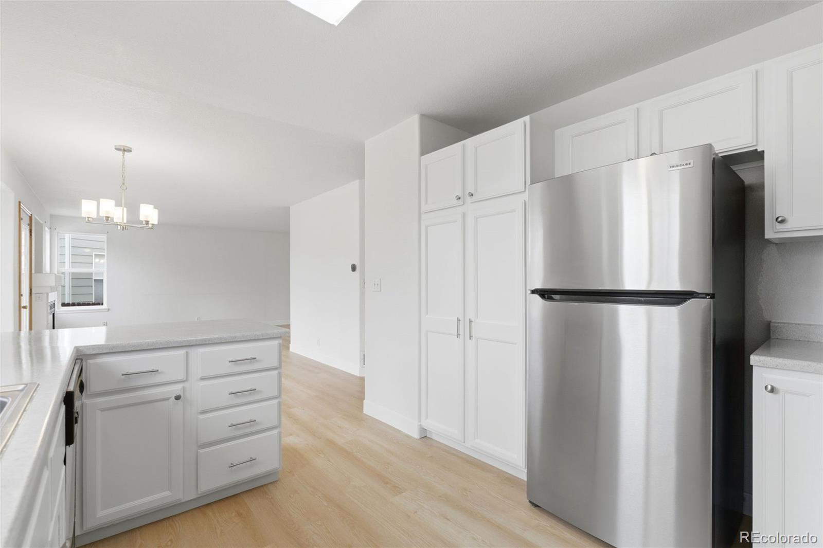 10505 Madison Way Northglenn, CO 80233 - Photo 17 of 49 a kitchen with white cabinets and refrigerator