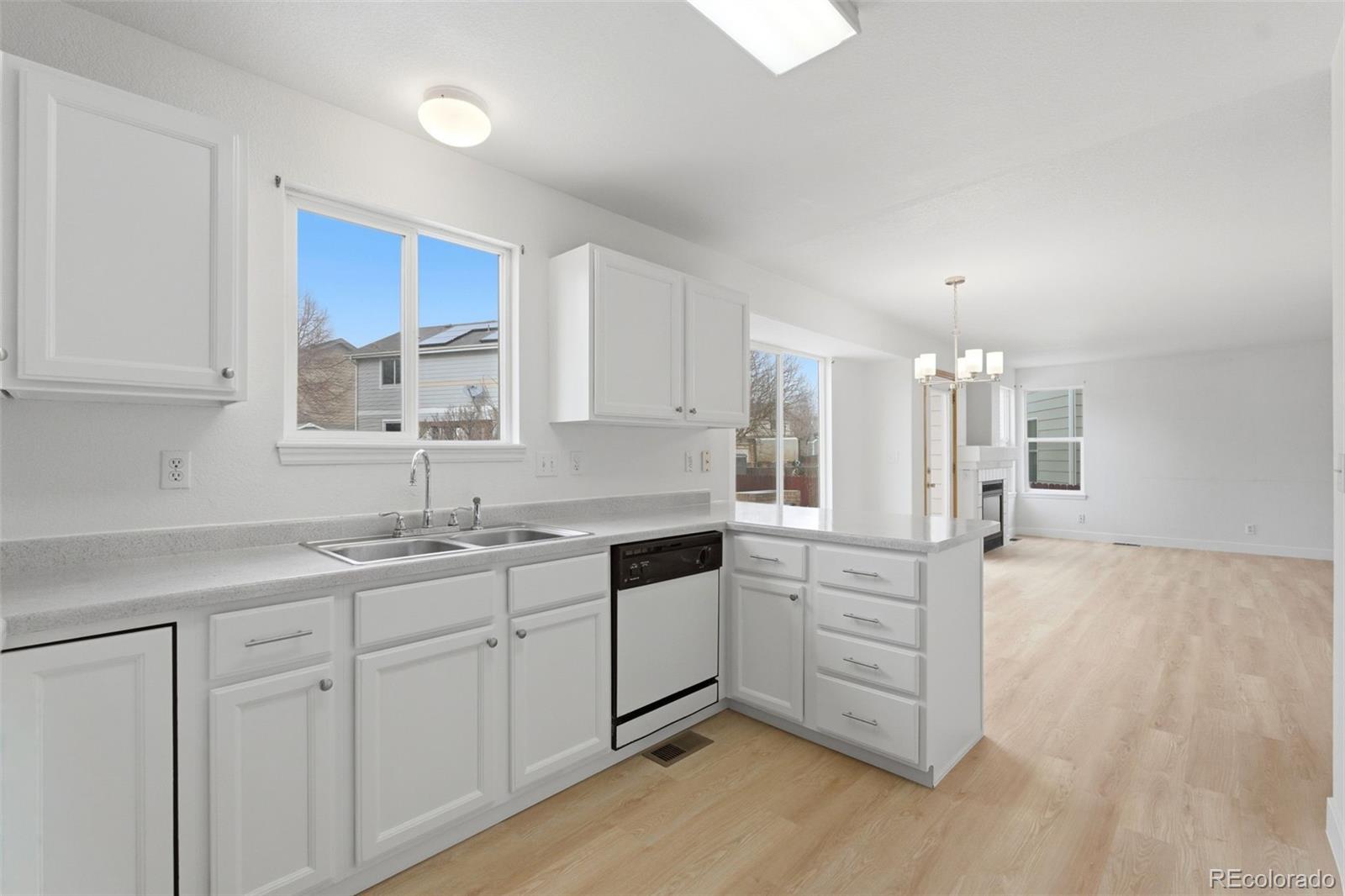 10505 Madison Way Northglenn, CO 80233 - Photo 18 of 49 a kitchen with white cabinets and sink