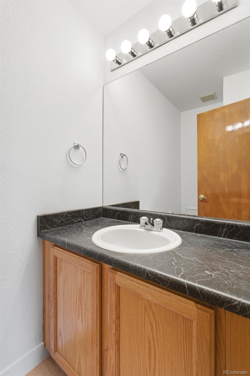 10505 Madison Way Northglenn, CO 80233 - Photo 21 of 49 a bathroom with a granite countertop sink and a mirror