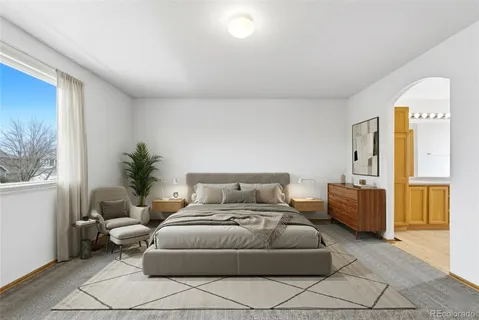 a bedroom with furniture and a window