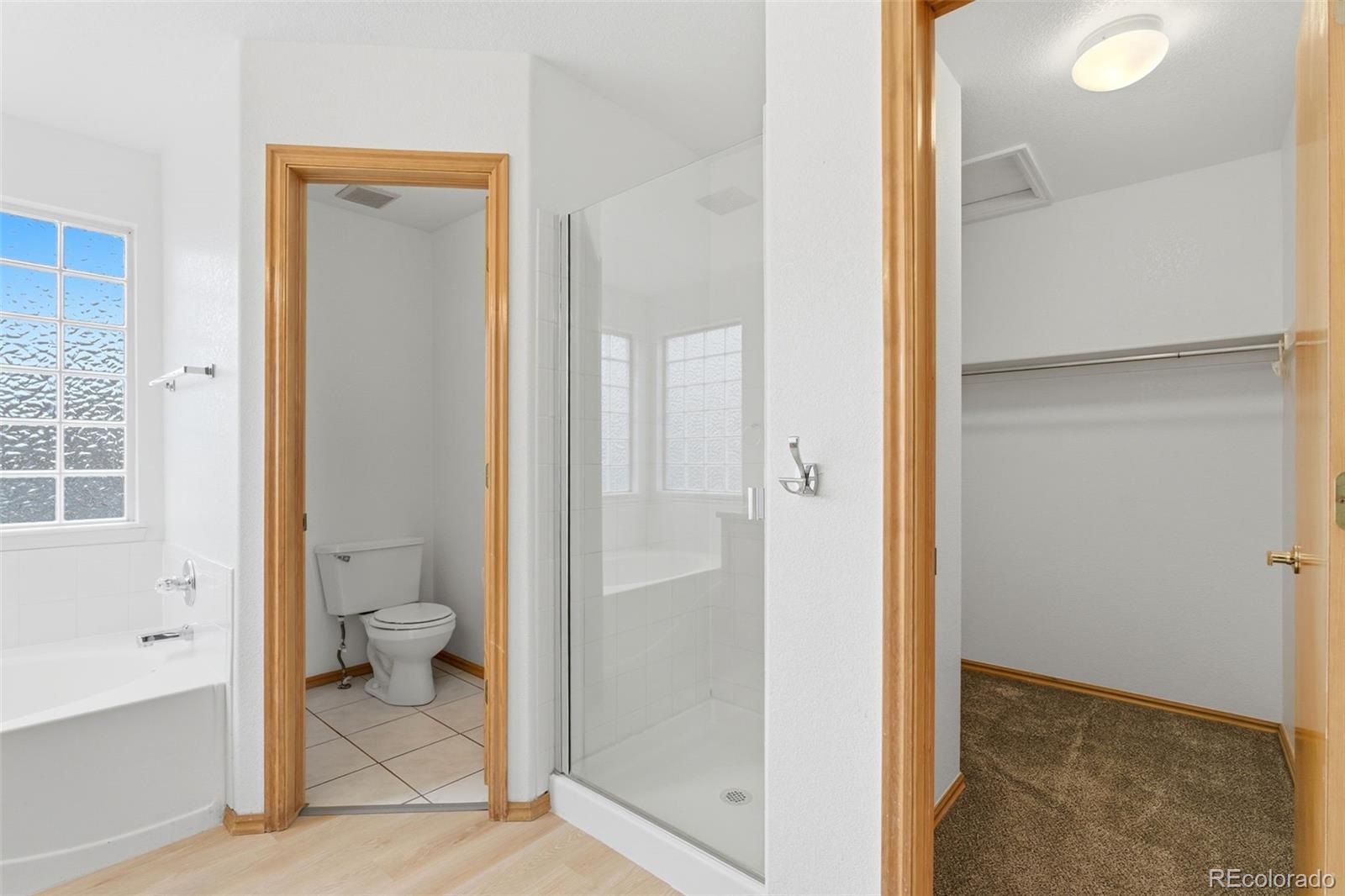 10505 Madison Way Northglenn, CO 80233 - Photo 29 of 49 a bathroom with a granite countertop toilet and a shower