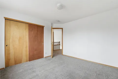 a view of an empty room and a window