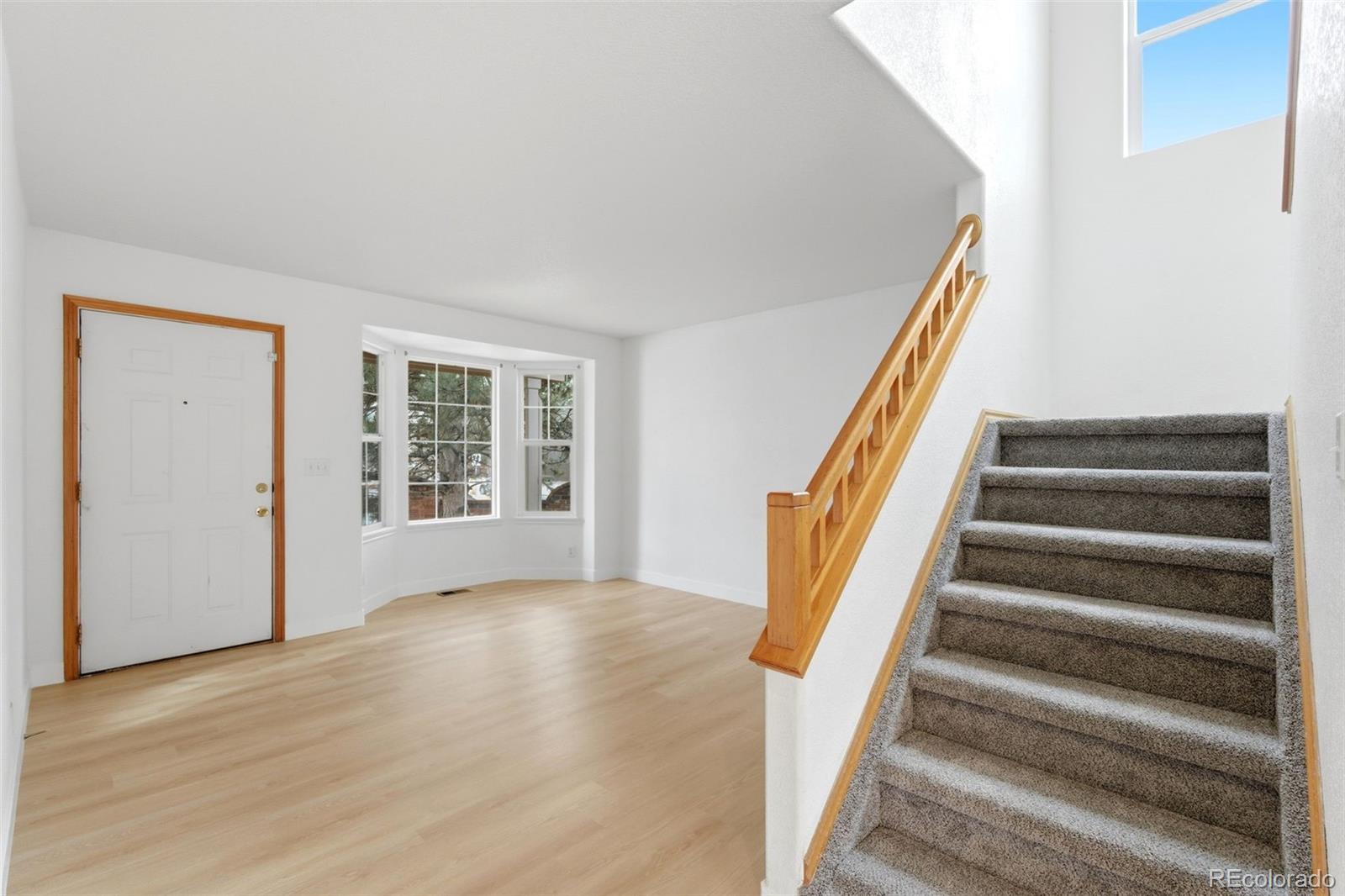 10505 Madison Way Northglenn, CO 80233 - Photo 5 of 49 a view of an entryway with wooden floor