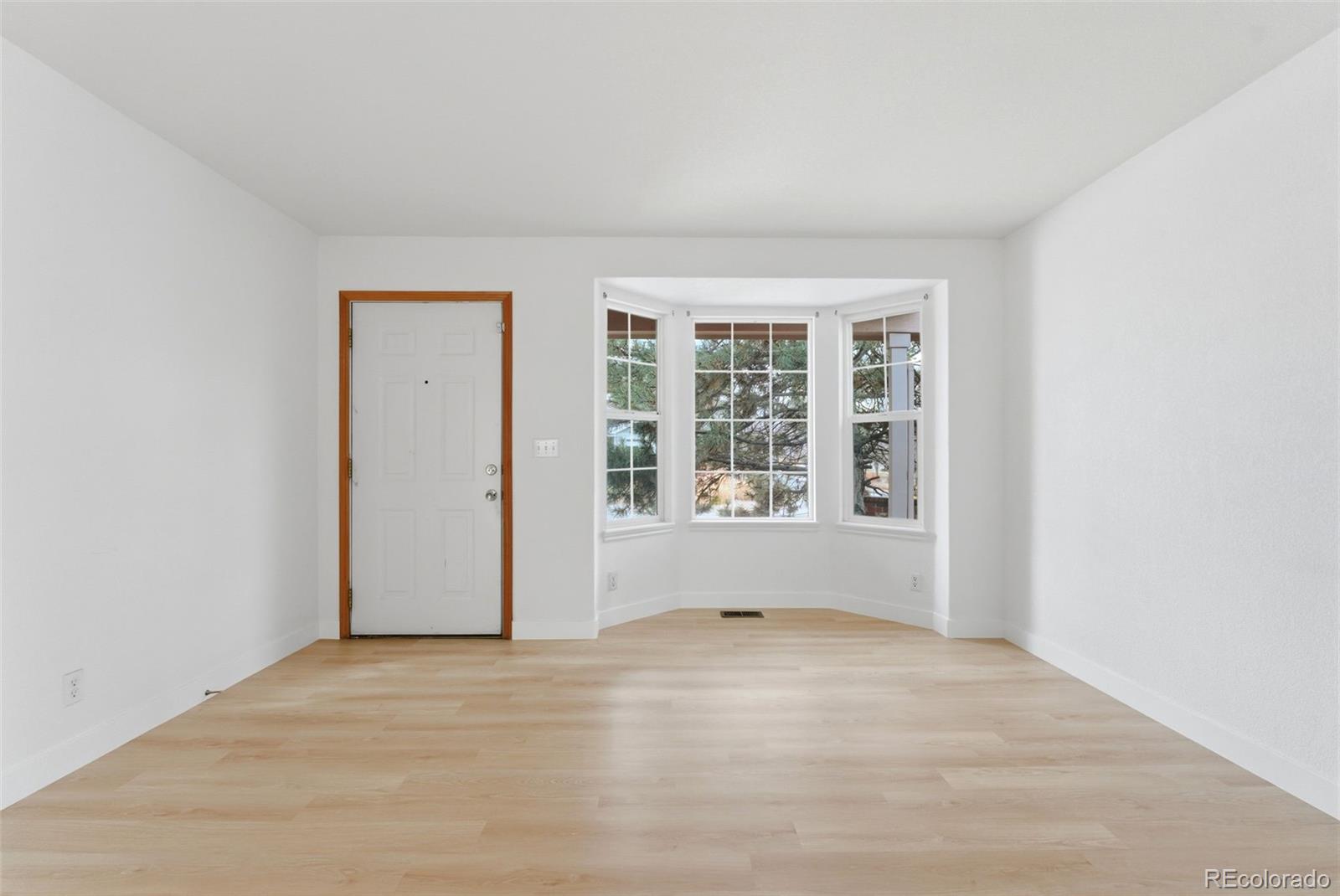 10505 Madison Way Northglenn, CO 80233 - Photo 6 of 49 an empty room with windows