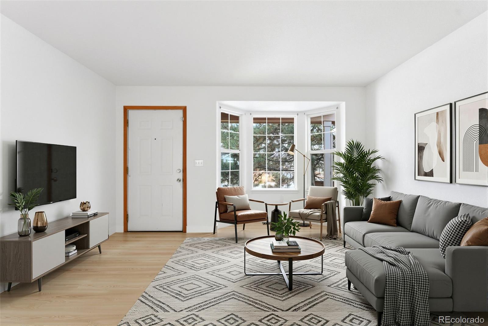 10505 Madison Way Northglenn, CO 80233 - Photo 7 of 49 a living room with furniture and a flat screen tv