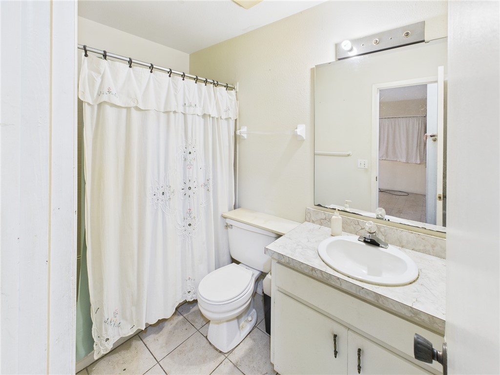 2265 14th Avenue Southwest Vero Beach, FL 32962 - Photo 11 of 20 a bathroom with a granite countertop sink toilet and shower