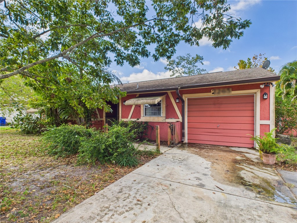 2265 14th Avenue Southwest Vero Beach, FL 32962 - Photo 2 of 20 a front view of a house with a yard