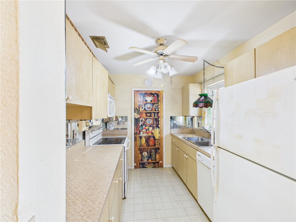 2265 14th Avenue Southwest Vero Beach, FL 32962 - Photo 3 of 20 a view of a kitchen with fridge and a workspace