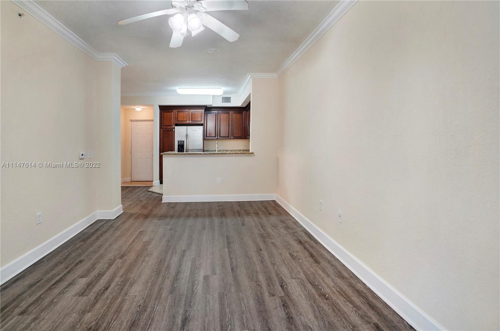 1660 Renaissance Commons Boulevard, Unit 2203 Boynton Beach, FL 33426 - Photo 11 of 20 wooden floor in an empty room with a window