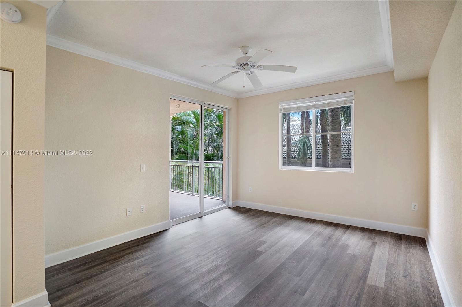 1660 Renaissance Commons Boulevard, Unit 2203 Boynton Beach, FL 33426 - Photo 13 of 20 a view of an empty room with wooden floor and a window