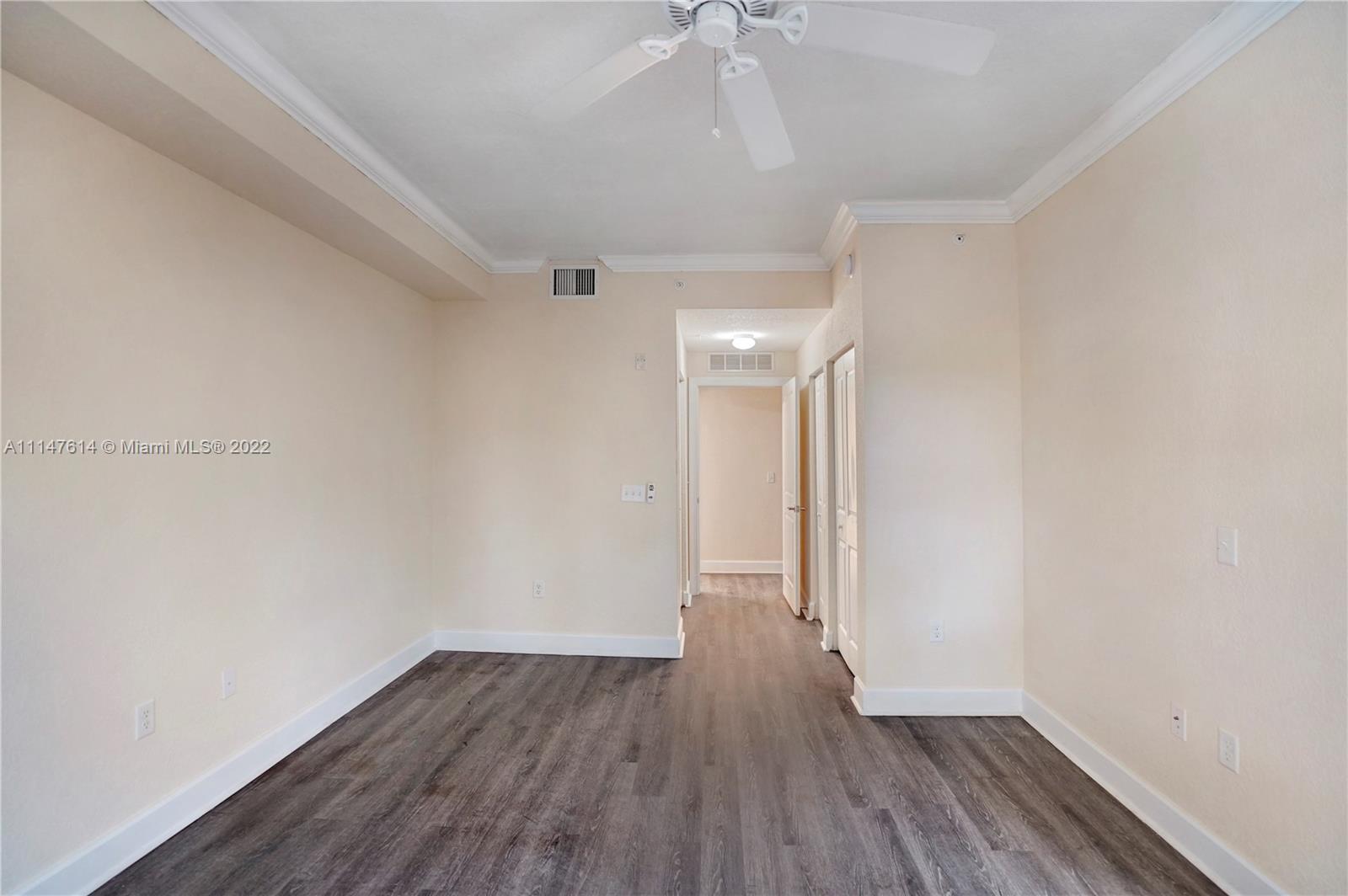 1660 Renaissance Commons Boulevard, Unit 2203 Boynton Beach, FL 33426 - Photo 15 of 20 a view of an empty room with wooden floor